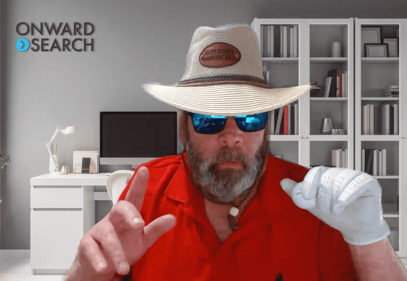 Onward team member on a video call wearing a cowboy hat, sunglasses, and a red shirt.